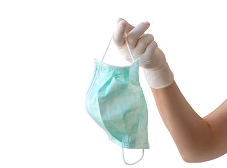 Hand holding face mask on white background