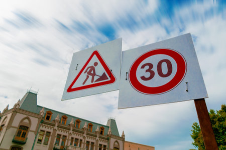 Men at road work and speed limit sign placed on the capital city of Geogiaの写真素材