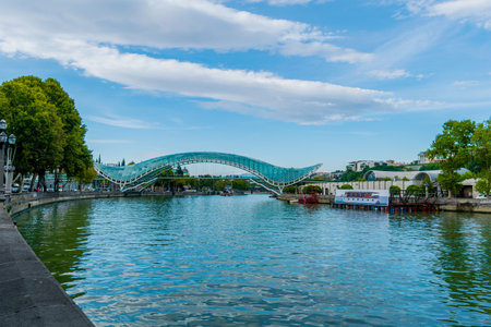 Tbilisi, Georgia - October 1, 2017: The Bridge of Peace is a bow-shaped pedestrian bridge, a steel...