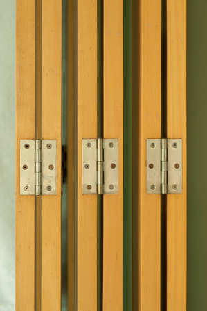hinges on beige wood door