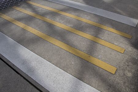 Shadow on Yellow And White Crosswalkの写真素材