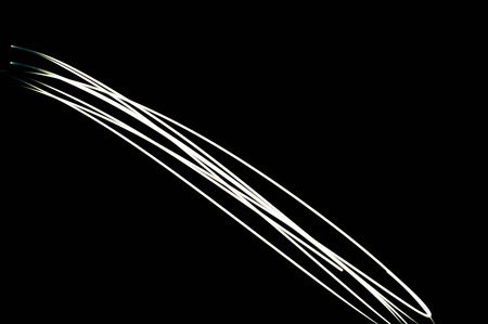 white light long exposure, white light line on black backgroundの写真素材