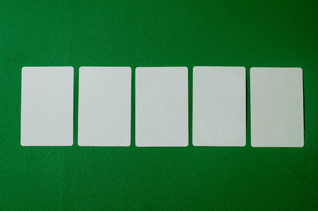 mock-up blank poker card in green background