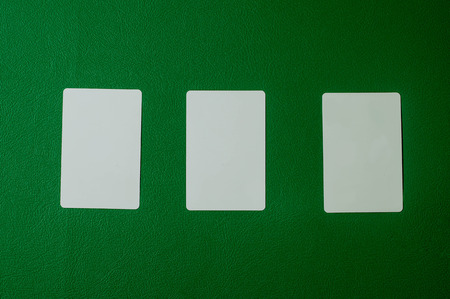mock-up blank poker card in green backgroundの写真素材