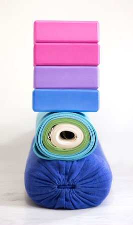 Varicolored iyengar yoga props. Yoga blocks, bolster, strap and carpetsの写真素材