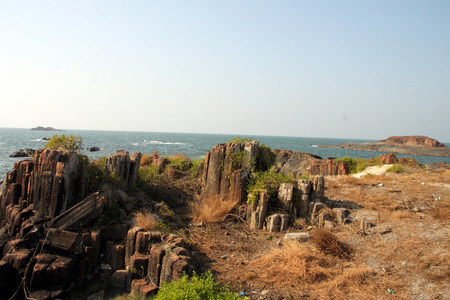 Beautiful rocks formed due to volcanic eruption,  with a naturally formed hexagonal shape, facing the nice blue sea, overlooking the blue skyの写真素材