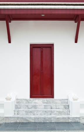 Wooden door on white wall.の写真素材