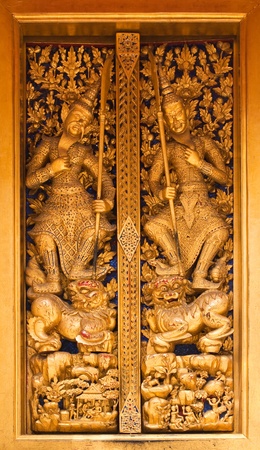 Close up of Thai style wood carving on the door of church in thai temple,Thailand.の写真素材