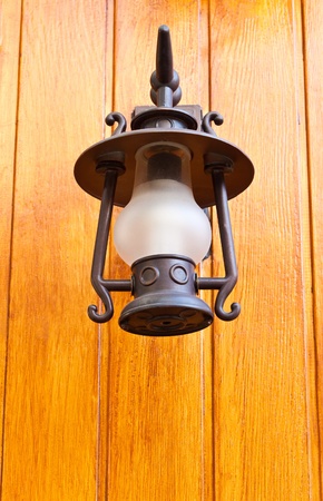 old-fashion lamp hanging on wooden wall の写真素材