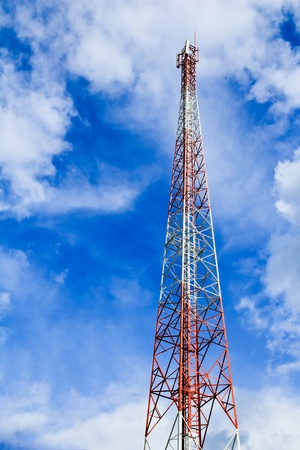 Telecommunication mast with microwave link and TV transmitter antennas over a blue sky. の写真素材