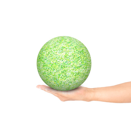 hand holding green grass ball isolated on white background used for green earth concept の写真素材