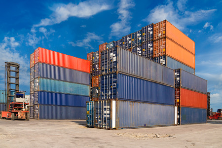 Colorful containers stacked at harbor freight terminal against blue sky backgroundのeditorial素材