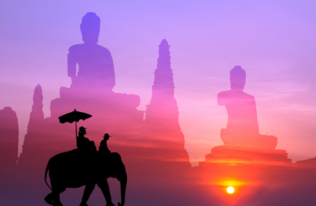 silhouette elephant with tourist with big buddha background at sunset,visit to Thailand conceptの写真素材