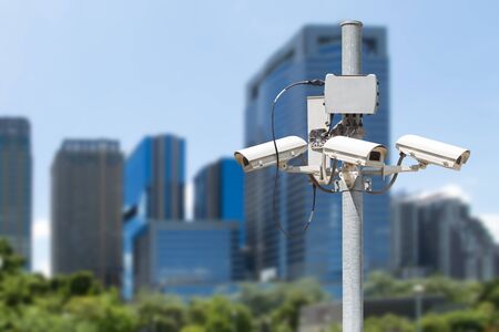 CCTV pillar with the building in the city background used for security concept