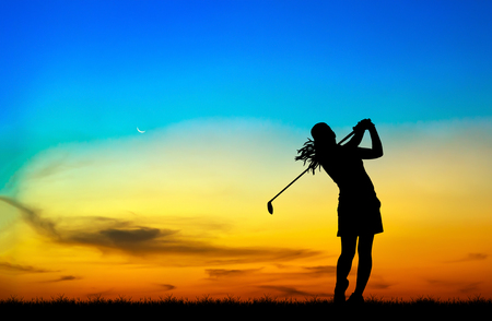 silhouette golfer playing golf during beautiful sunsetの写真素材