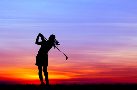 silhouette golfer playing golf during beautiful sunsetの写真素材