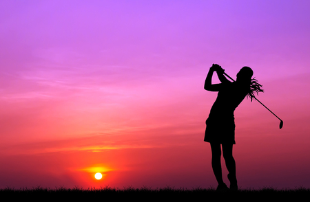 silhouette golfer playing golf during beautiful sunsetの写真素材