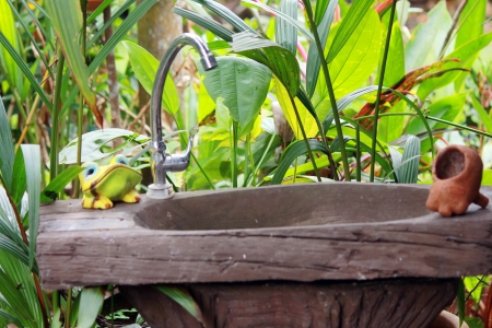 Water faucet and basin in gardenの写真素材