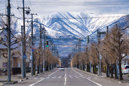 straight road and mountain in winterの写真素材