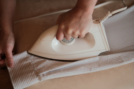 woman ironing shirt at homeの写真素材