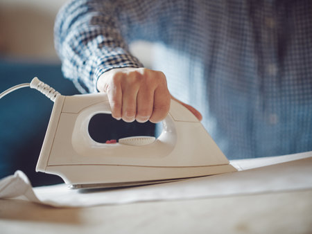 woman ironing shirt in homeの写真素材