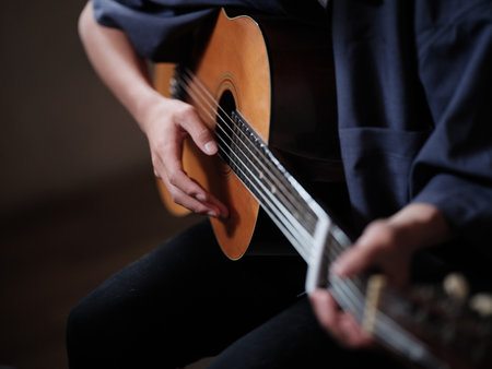 The person who plays the guitar