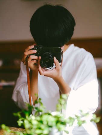 Photographer shooting with a classic cameraの写真素材