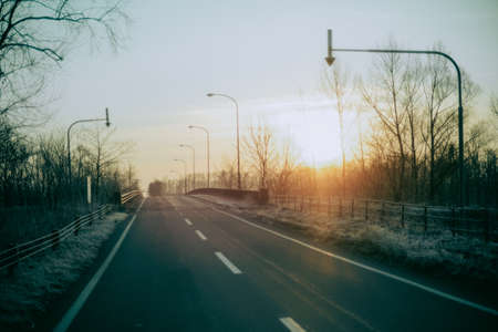 road and sunrise in winterの写真素材