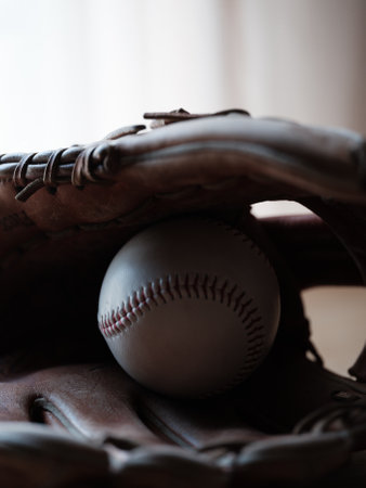 glove and baseball ball on table