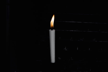 Lighted candle and black backgroundの写真素材
