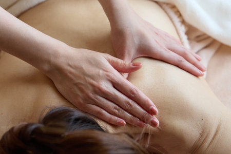 A woman receiving a body treatmentの写真素材