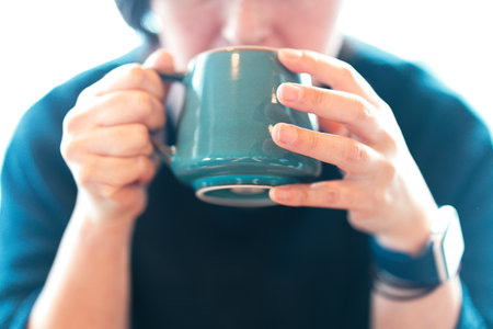 hand holding a coffee cup