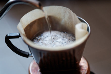 Pour hot water into coffee beansの写真素材