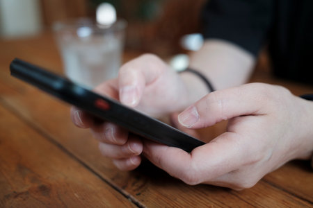 A person looking at a smartphone in a cafe