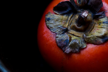 Persimmon on the black tableの写真素材