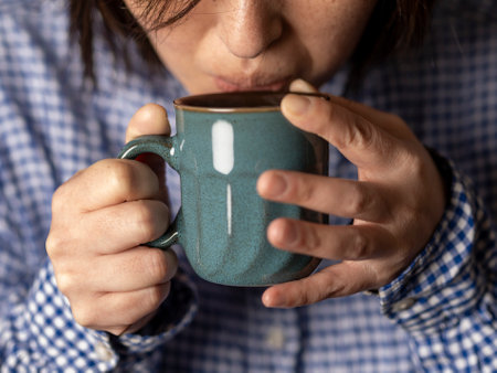 woman hold coffee cup in cafeの写真素材