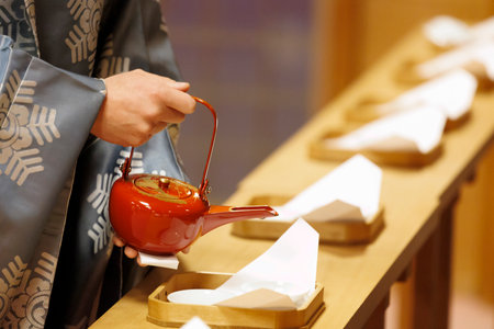 Hands offering miki at the shrineの写真素材