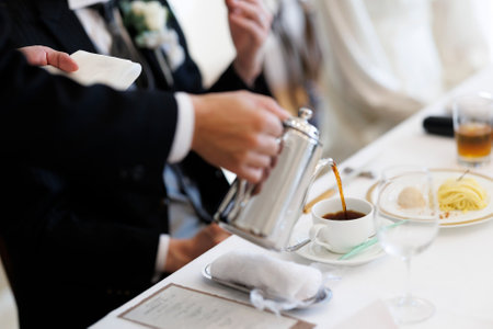 Waiter pouring coffee in partyの写真素材