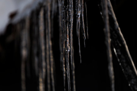 Close up of icicles hanging from the ceiling of a cave.の写真素材