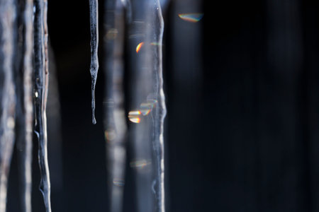 Icicles on a black background, close-up, macro