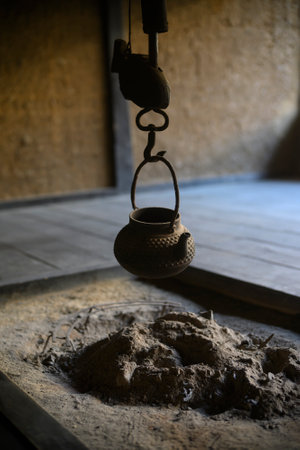 Old clay pot hanging on a hook in a factory, closeup of photoの写真素材