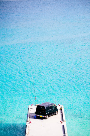 blue sea and minivan in okinawaの写真素材
