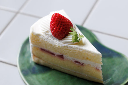 Strawberry cake on plate, selective focus. Shallow DOF.