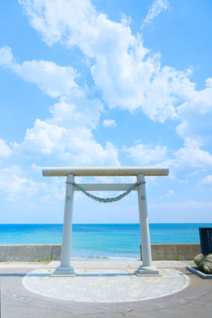 Japanese Gate on the beach with blue sky and white clouds background.の写真素材