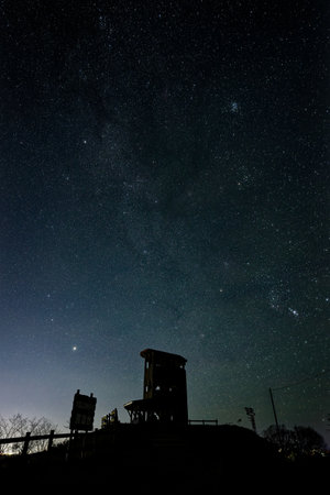 Milky Way over the Silhouette of a Watchtower at nightの写真素材