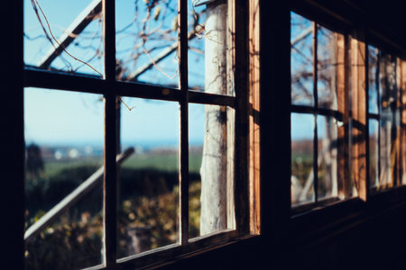 Old wooden window in an abandoned house on the background of blue skyの写真素材