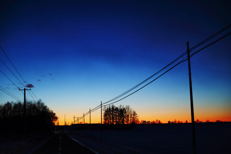 Scenery with the pre-dawn sky and electric polesの写真素材