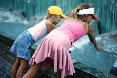 Two girls at fountainの写真素材
