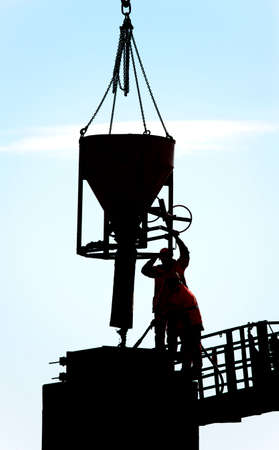 Two builders pouring cementの写真素材