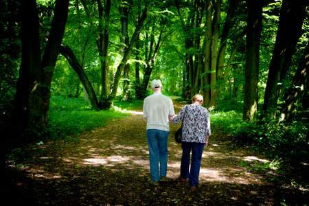 Elderly couple walking in the spring parkの写真素材